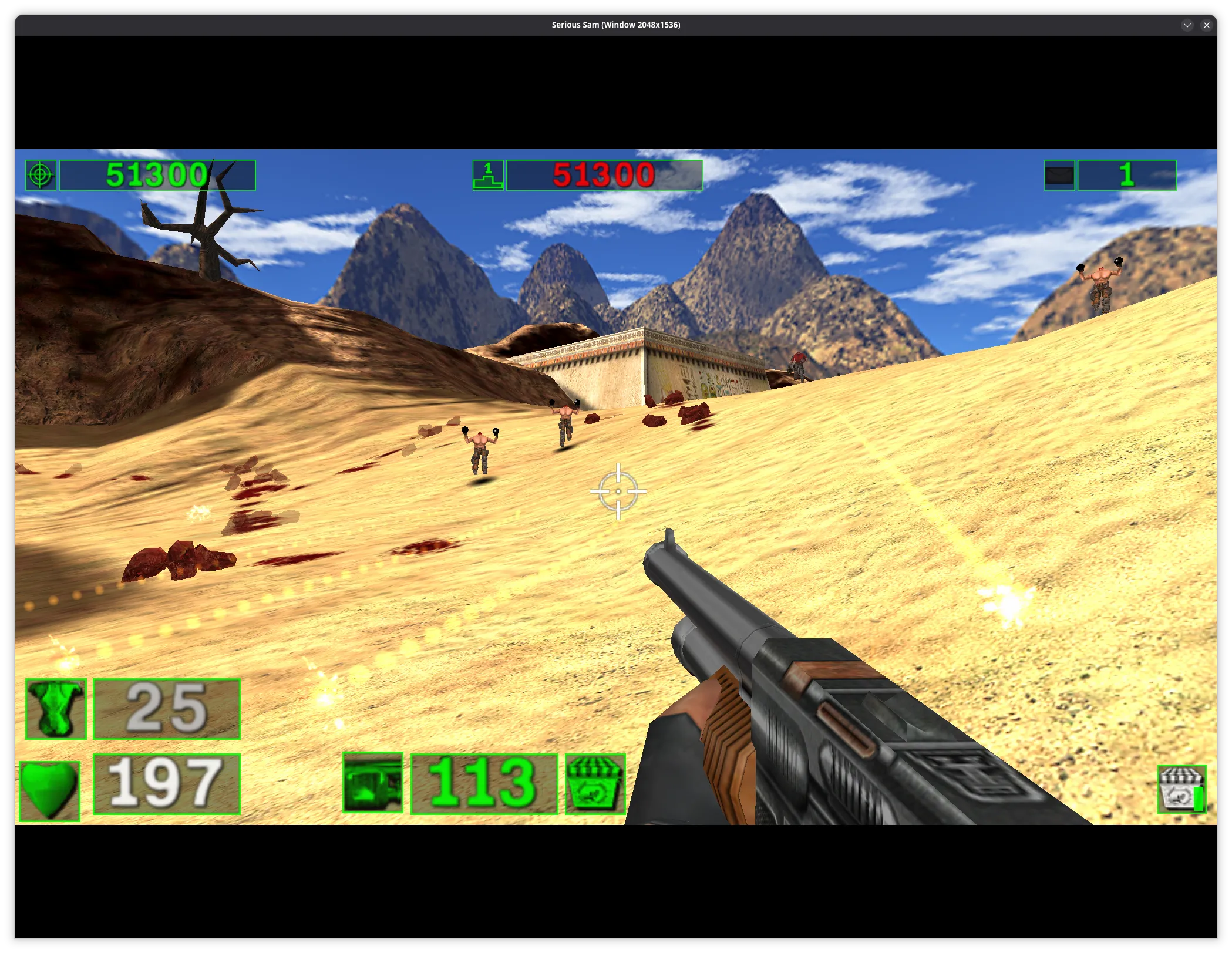 First-person shooter gameplay set in a bright desert environment. The player aims a shotgun while moving across sandy dunes toward several humanoid enemies approaching from mid-distance. Blood stains and debris dot the sand. In the background are rocky mountains and a small stone temple-like structure. A classic HUD overlays the screen, showing score, ammo, health, armor, and a central crosshair.