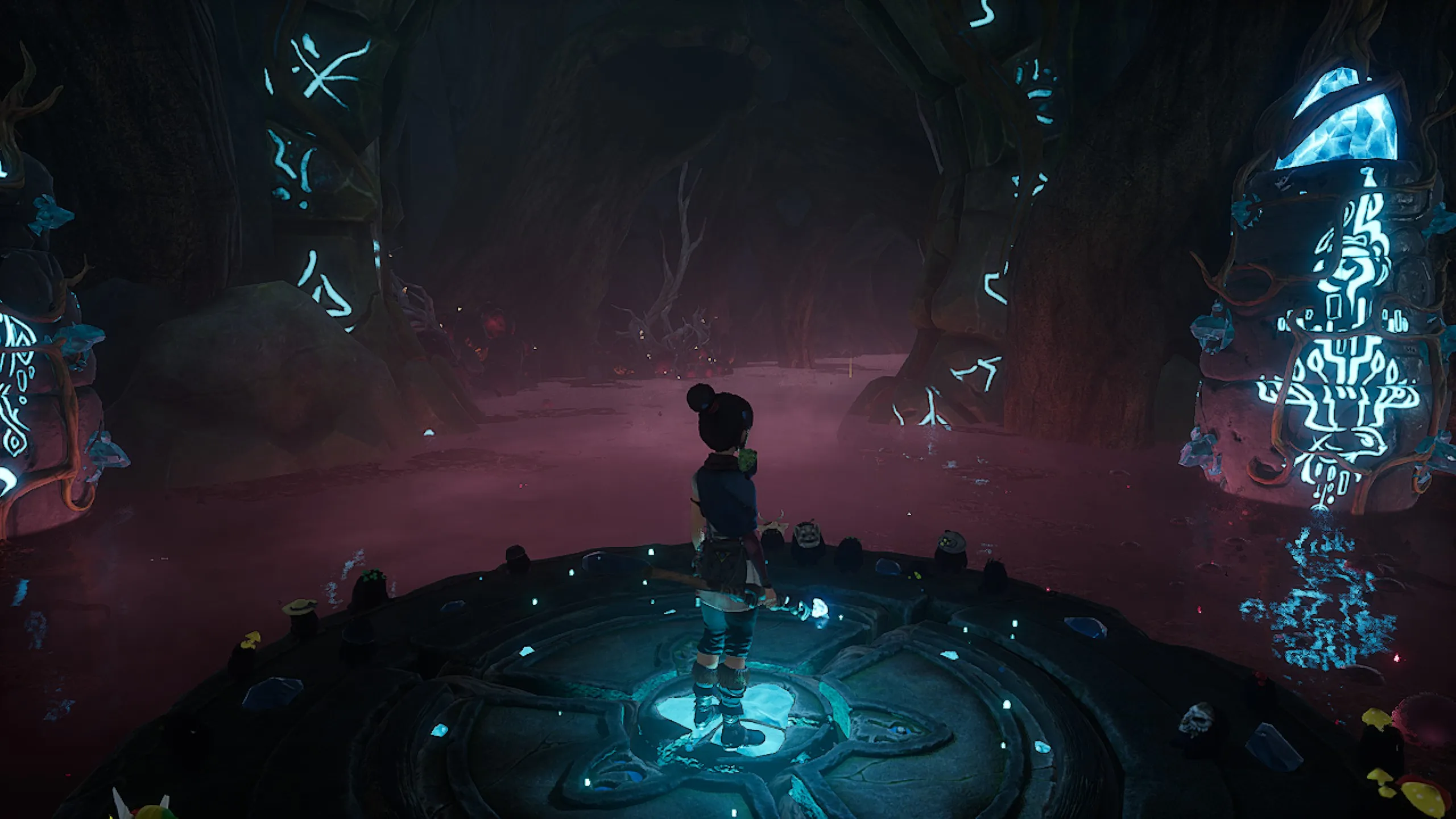 In-game screenshot from Kena: Bridge of Spirits showing Kena standing on a glowing circular stone platform in a dark, corrupted forest arena. The environment is bathed in deep red and purple hues, with glowing teal runic symbols on stone pillars flanking the scene. Small Rot companions are scattered around the platform, and a shadowy threat looms in the misty background.