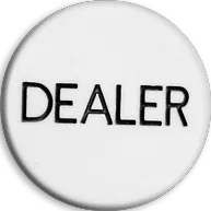 A white poker chip with the word “DEALER” written in black capital letters in the center.
