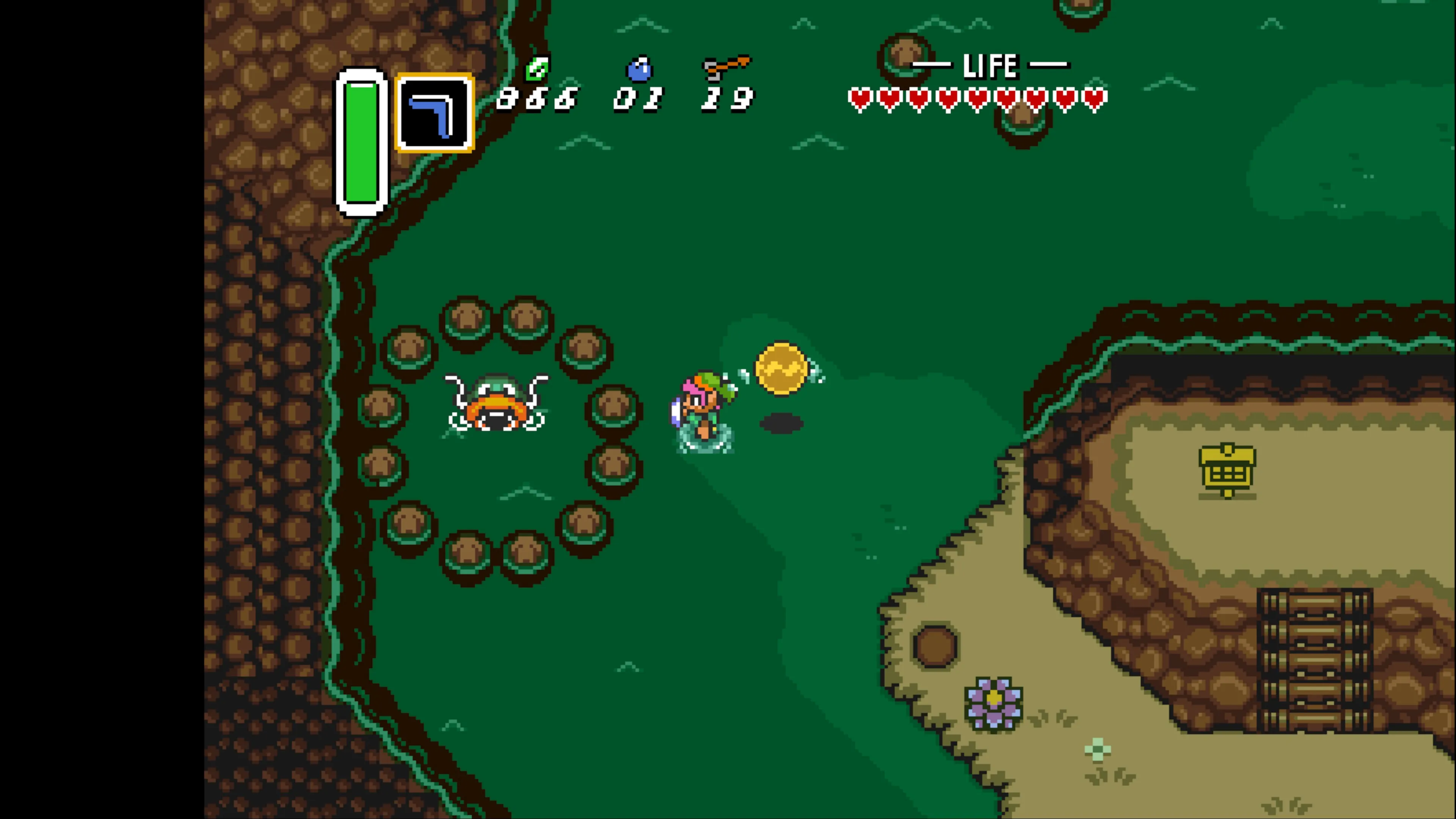The image displays Link, the green-clad protagonist, standing in a grassy outdoor area surrounded by a circular formation of dark tree rocks. Link appears to be holding a glowing yellow orb of magic. The scene includes typical Zelda UI elements: a life meter showing red heart containers in the upper right, item inventory slots in the upper left showing what appears to be a boomerang and other tools, and numerical counters (possibly for rupees and other collectibles). The environment features green grass terrain, brown rocky/dirt areas, and stone walls or cliffs. The pixel art style and color palette are characteristic of the Super Nintendo era of Zelda games.