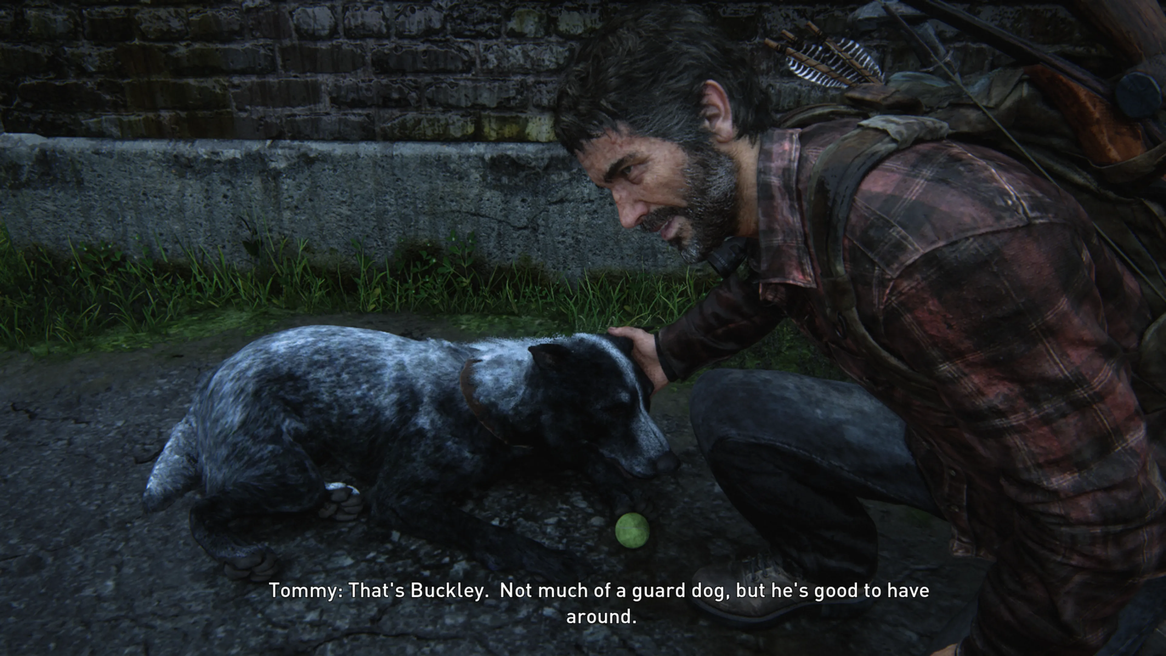 A bearded man in worn outdoor gear crouches down to pet a blue-gray Australian Cattle Dog near a stone wall, with game subtitles reading ’Tommy: That’s Buckley. Not much of a guard dog, but he’s good to have around.