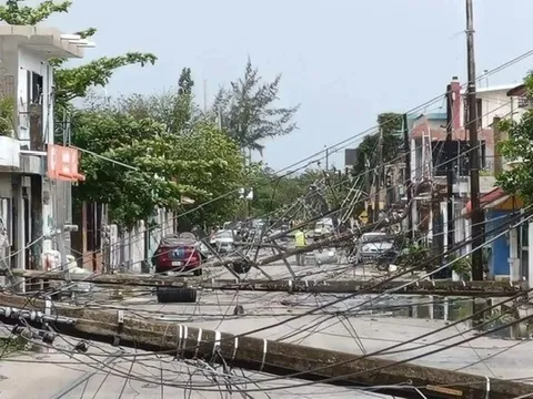 Several power lines are down in this photo, some hanging over cars, but the photo shows that almost the entire road is blocked due to the downed lines